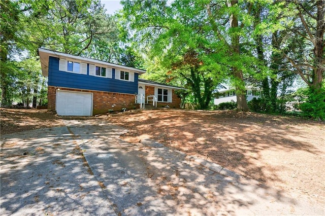 5287 Chantilly Ter, Atlanta, GA 30349 - split level home featuring concrete driveway, brick siding, and a garage