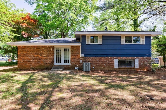 5287 Chantilly Ter, Atlanta, GA 30349 - back of property featuring french doors, central AC unit, and brick siding