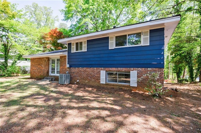 5287 Chantilly Ter, Atlanta, GA 30349 - view of side of property featuring central AC, french doors, and brick siding