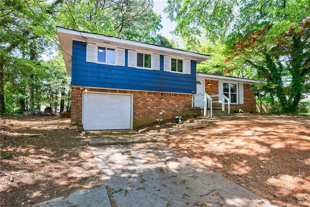 5287 Chantilly Ter, Atlanta, GA 30349 - split level home with concrete driveway, brick siding, and an attached garage