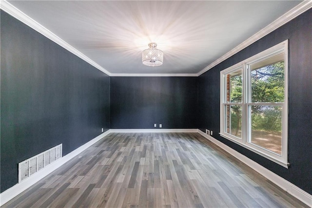 5287 Chantilly Ter, Atlanta, GA 30349 - empty room featuring visible vents, an inviting chandelier, crown molding, and wood finished floors