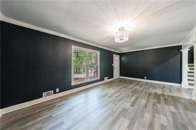 5287 Chantilly Ter, Atlanta, GA 30349 - spare room with a notable chandelier, baseboards, ornamental molding, visible vents, and wood finished floors