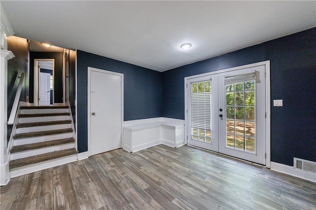 5287 Chantilly Ter, Atlanta, GA 30349 - interior space featuring stairway, french doors, wainscoting, visible vents, and wood finished floors