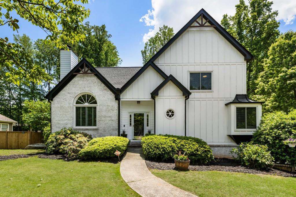5600 Surrey Ct, Alpharetta, GA 30009 - view of front of property featuring brick siding, board and batten siding, a chimney, and roof with shingles