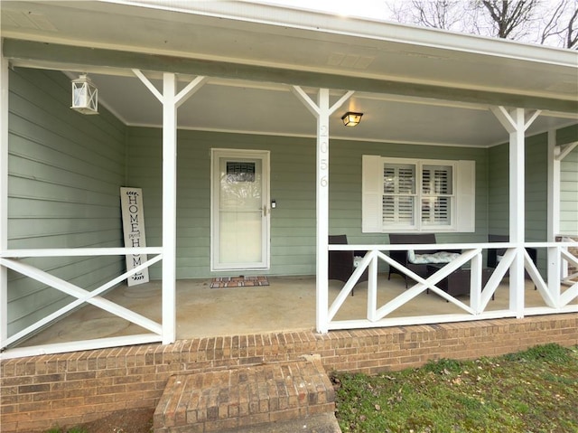 view of exterior entry with a porch