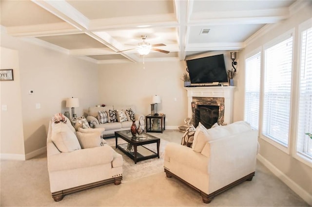 living area with baseboards, coffered ceiling, and a wealth of natural light