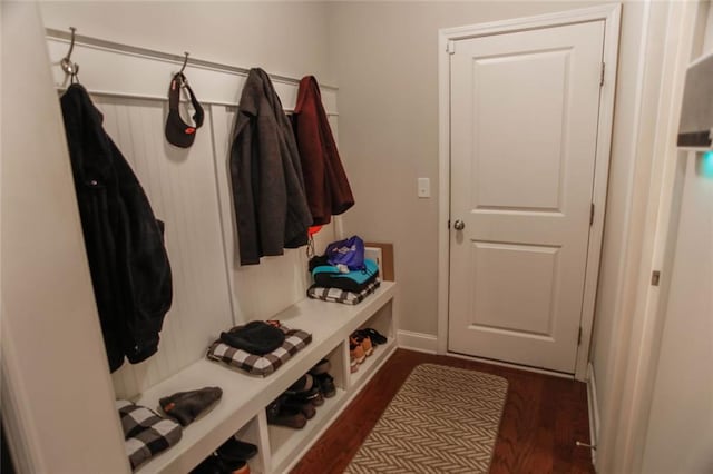 mudroom featuring baseboards and dark wood-style flooring