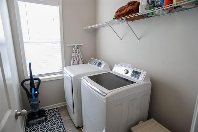 laundry room featuring laundry area, light tile patterned floors, baseboards, and washer and clothes dryer