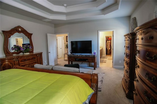 bedroom with ornamental molding, ensuite bath, carpet, and a raised ceiling