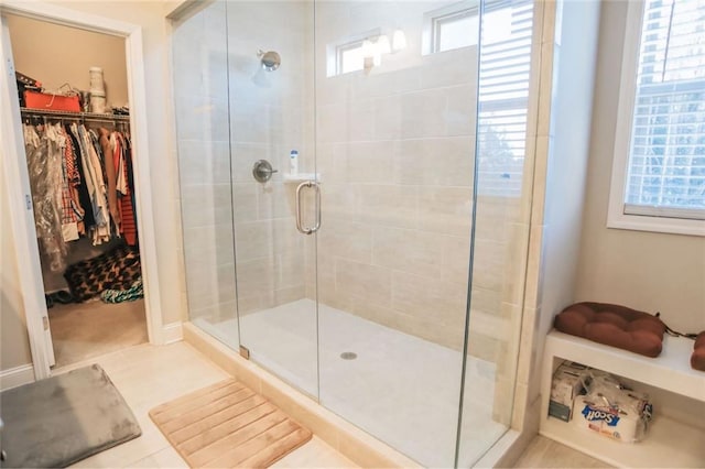 full bathroom with a shower stall and a spacious closet