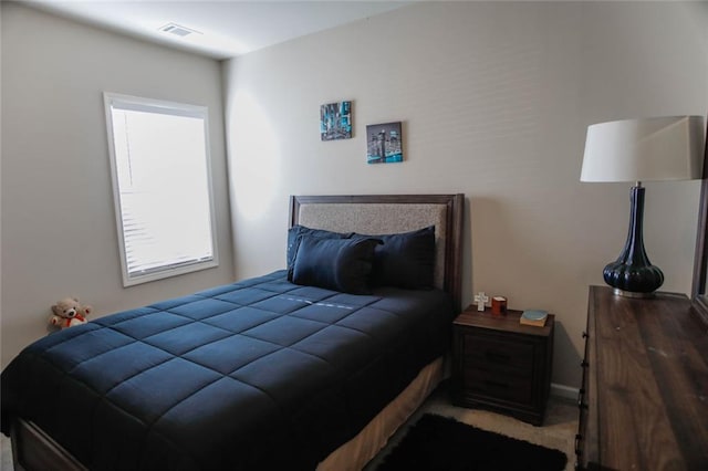 bedroom with carpet floors and visible vents