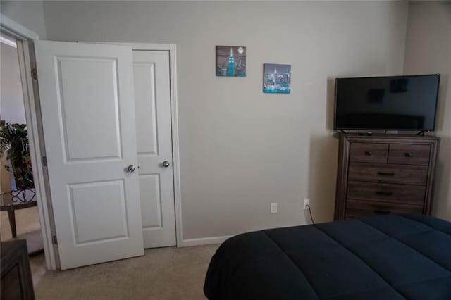 bedroom featuring carpet and baseboards