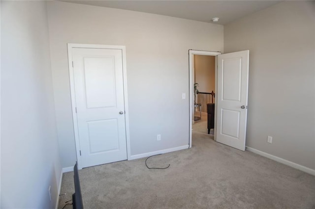 unfurnished bedroom with carpet and baseboards