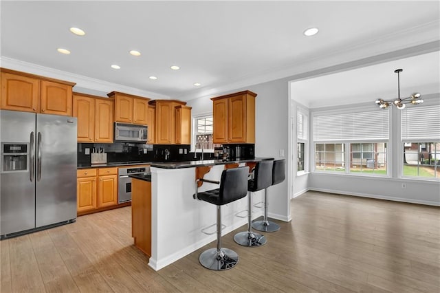 2207 Concordia Way SE Unit 12, Mableton, GA 30126 - kitchen with appliances with stainless steel finishes, crown molding, dark countertops, light wood-style flooring, and backsplash