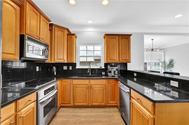 2207 Concordia Way SE Unit 12, Mableton, GA 30126 - kitchen with stainless steel appliances, a sink, a peninsula, plenty of natural light, and crown molding