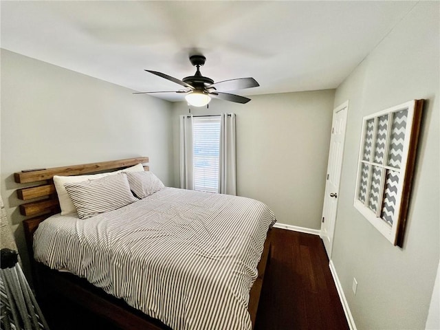 bedroom with ceiling fan, baseboards, and wood finished floors