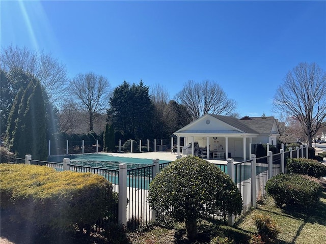 community pool featuring a patio and fence