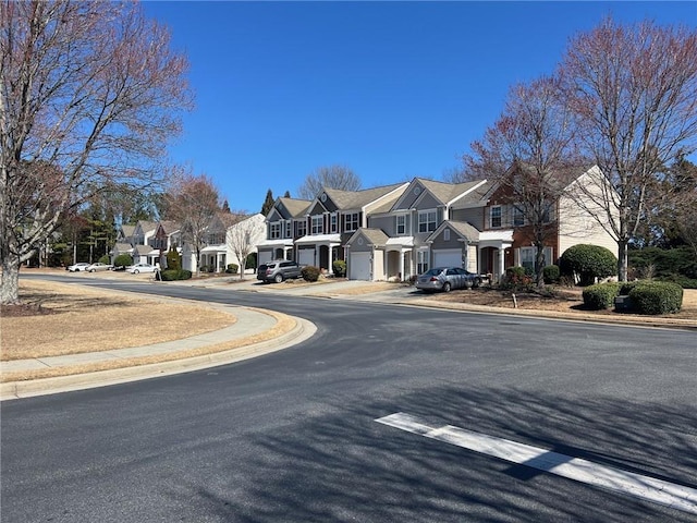 view of road with sidewalks, curbs, and a residential view