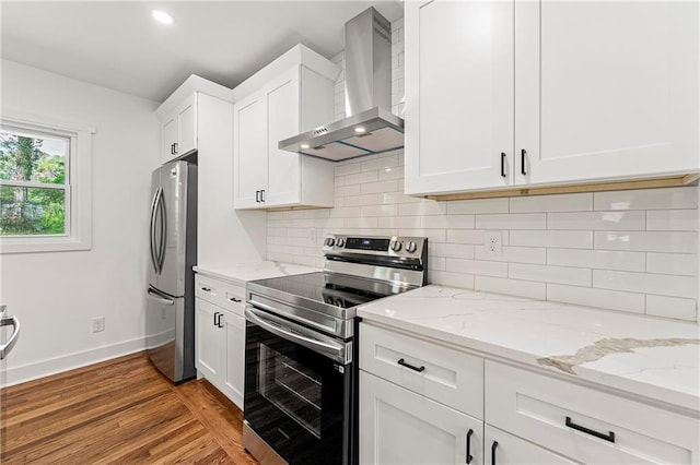 2146 Trailwood Rd, Decatur, GA 30032 - kitchen with light wood-style flooring, baseboards, white cabinetry, wall chimney range hood, and appliances with stainless steel finishes