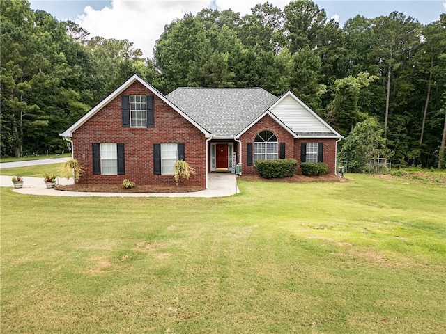 15 Fairwoods Ct, Covington, GA 30016 - view of front of home with brick siding, a front yard, and roof with shingles