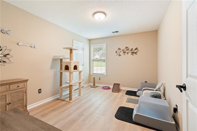15 Fairwoods Ct, Covington, GA 30016 - workout room with wood finished floors and a textured ceiling