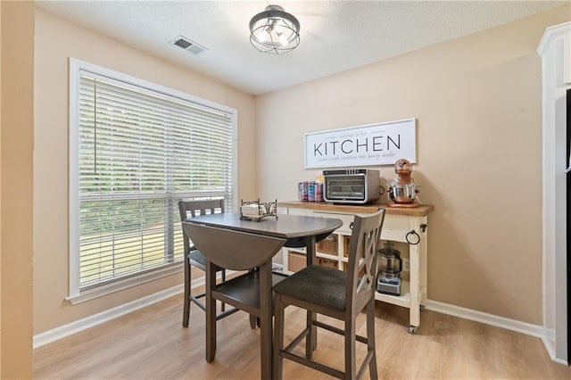 15 Fairwoods Ct, Covington, GA 30016 - dining area with light wood-style floors and baseboards