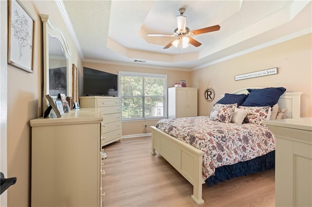 15 Fairwoods Ct, Covington, GA 30016 - bedroom featuring ornamental molding, light wood-style floors, a tray ceiling, and ceiling fan