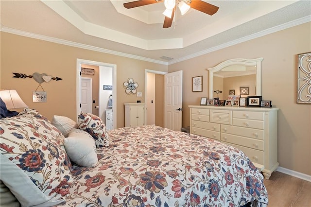 15 Fairwoods Ct, Covington, GA 30016 - bedroom with a tray ceiling, light wood-type flooring, ornamental molding, and a ceiling fan