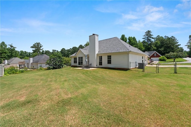 15 Fairwoods Ct, Covington, GA 30016 - back of property with a chimney, a patio area, and roof with shingles