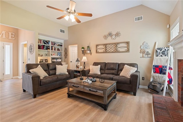 15 Fairwoods Ct, Covington, GA 30016 - living area featuring light wood-style floors, a ceiling fan, a fireplace, built in features, and vaulted ceiling