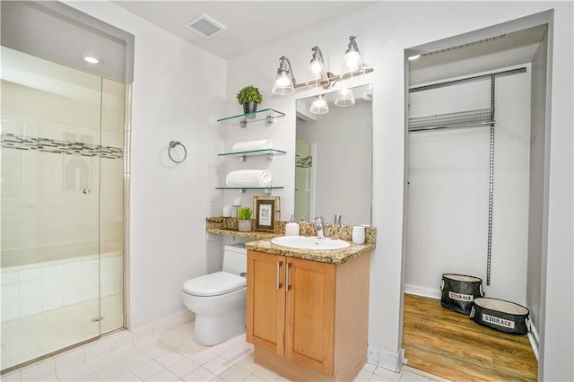 572 Edgewood Ave SE Unit # 106, Atlanta, GA 30312 - full bathroom with tile patterned floors, a stall shower, vanity, toilet, and visible vents