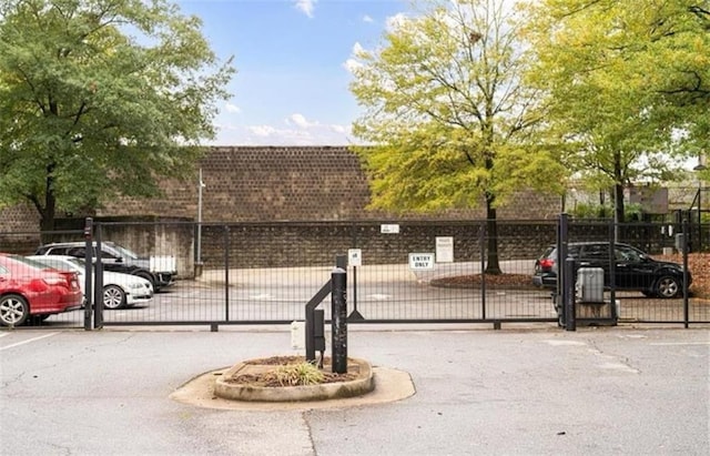 572 Edgewood Ave SE Unit # 106, Atlanta, GA 30312 - uncovered parking lot featuring fence and a gate