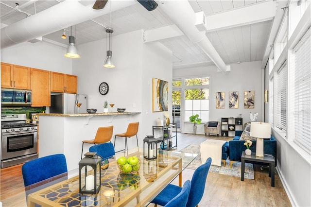 572 Edgewood Ave SE Unit # 106, Atlanta, GA 30312 - dining space with wood ceiling, baseboards, beam ceiling, and light wood-style flooring