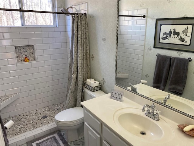 bathroom featuring vanity, toilet, and walk in shower