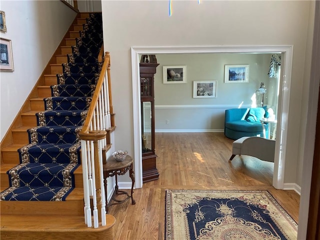 stairs featuring hardwood / wood-style floors