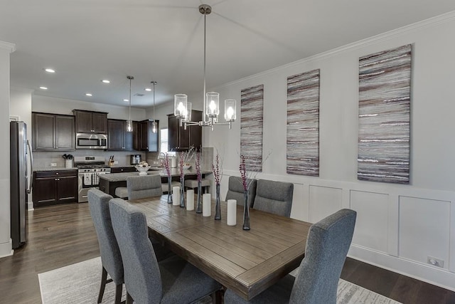 dining room with dark hardwood / wood-style floors, a notable chandelier, and ornamental molding