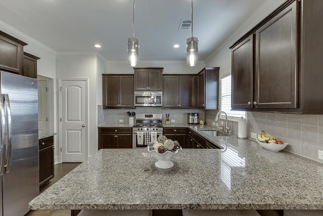 kitchen with sink, dark brown cabinets, light stone countertops, and appliances with stainless steel finishes