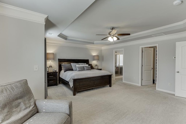 bedroom featuring ceiling fan, light colored carpet, crown molding, and a tray ceiling