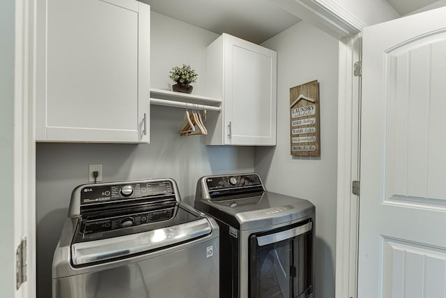 washroom featuring cabinets and separate washer and dryer