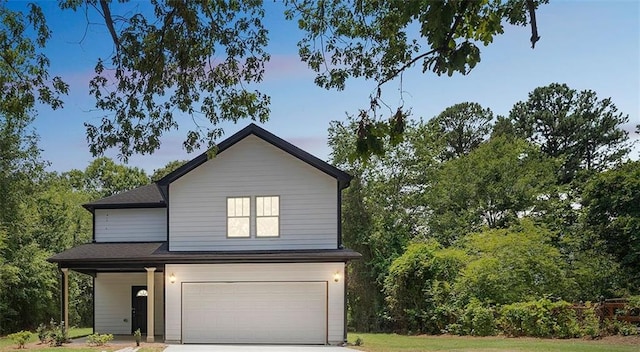 traditional-style home with an attached garage and concrete driveway