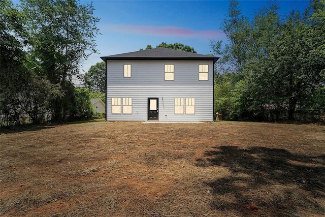 view of back of property at dusk