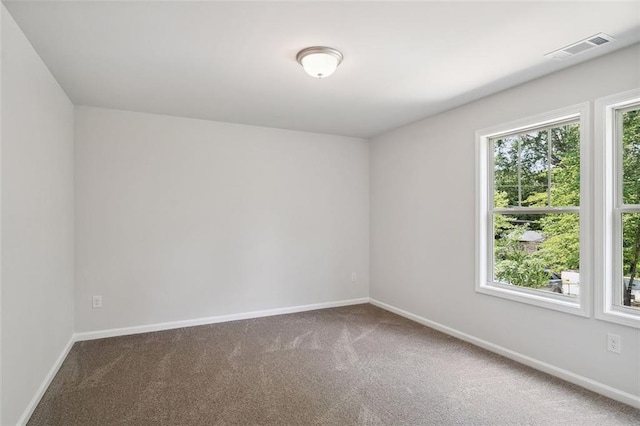 spare room with carpet floors and baseboards