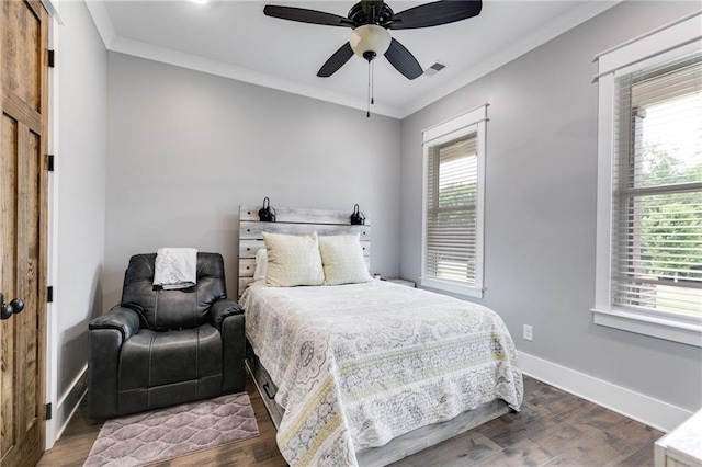 bedroom featuring dark hardwood / wood-style flooring, ornamental molding, and ceiling fan