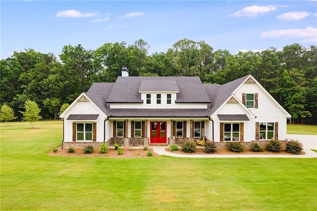 view of front facade with a front yard and covered porch