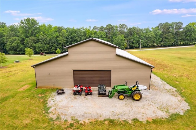 view of property exterior featuring a garage, an outbuilding, and a lawn