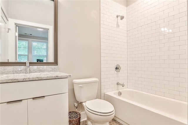 bathroom featuring washtub / shower combination, toilet, and vanity