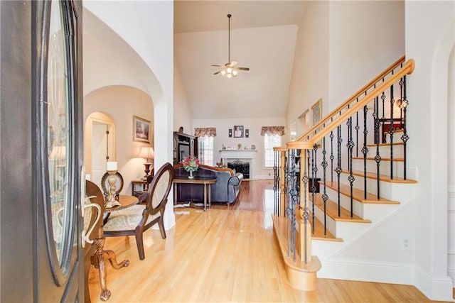 foyer featuring high vaulted ceiling, ceiling fan, and hardwood / wood-style flooring