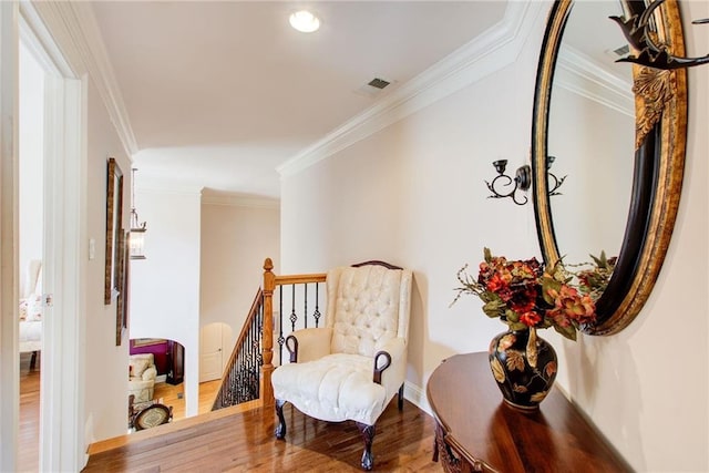 sitting room featuring ornamental molding and hardwood / wood-style floors