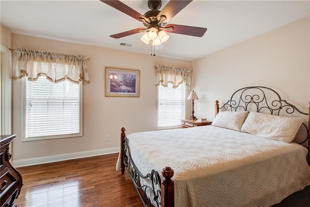 bedroom featuring multiple windows, wood-type flooring, and ceiling fan