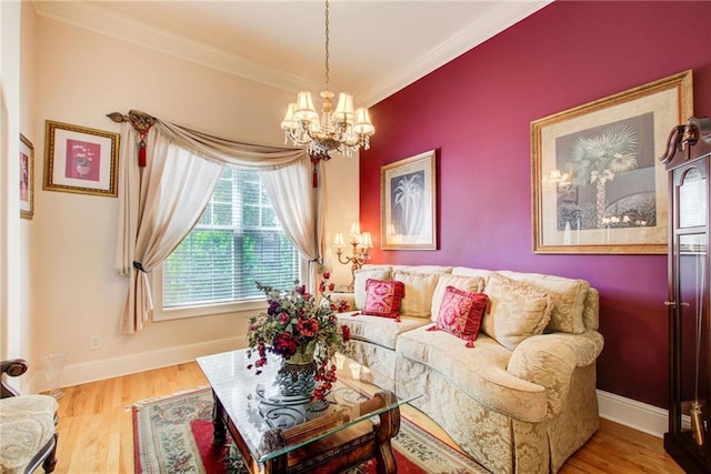 living room with light wood-type flooring, ornamental molding, and a notable chandelier